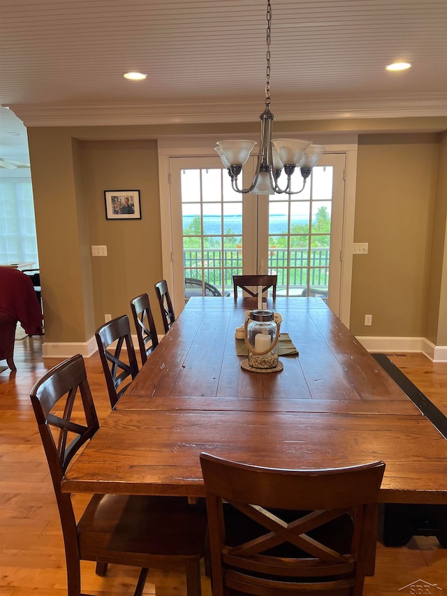 dining room with a chandelier, a healthy amount of sunlight, and ornamental molding