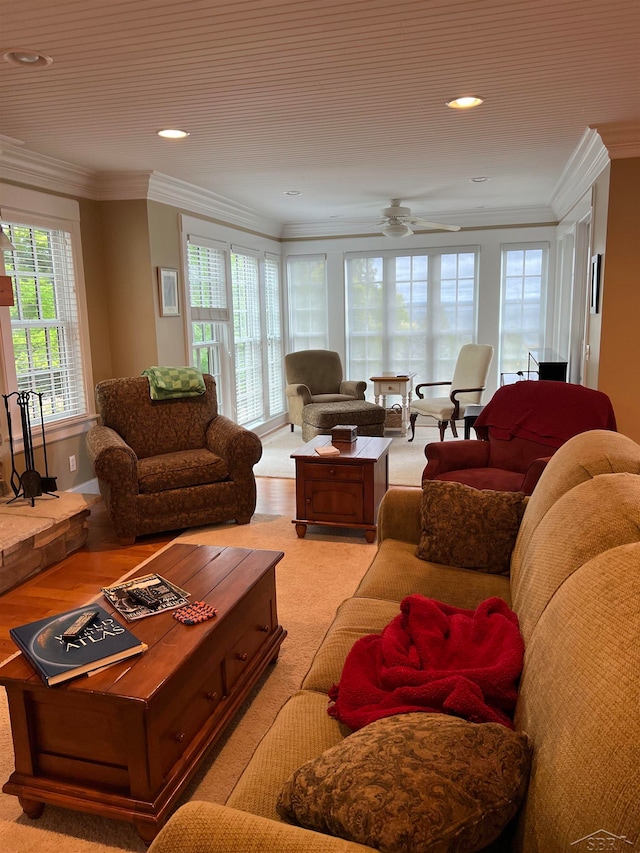 living room featuring light colored carpet, ceiling fan, and crown molding