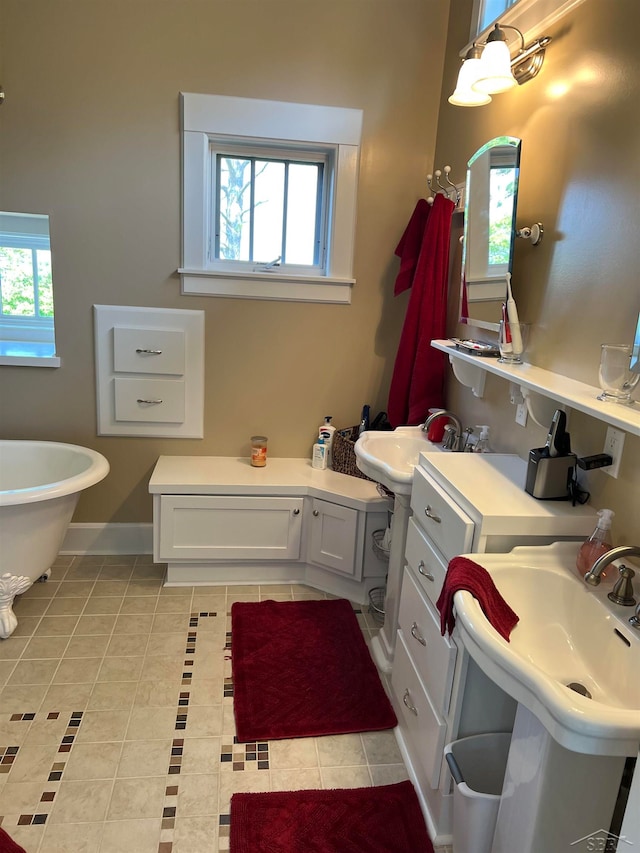 bathroom featuring tile patterned flooring, a bathtub, and sink