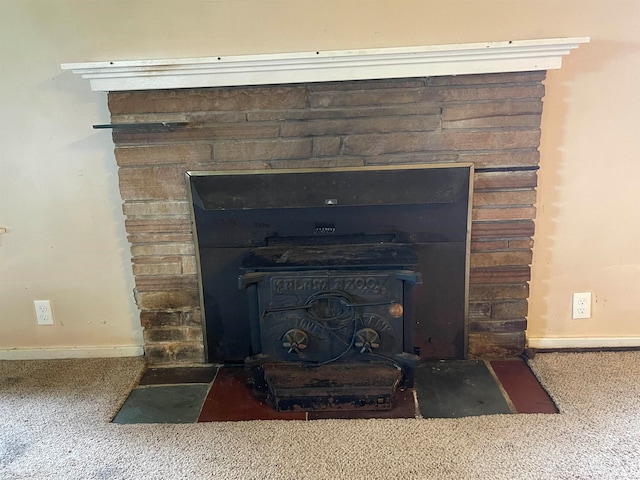 room details featuring a wood stove and carpet