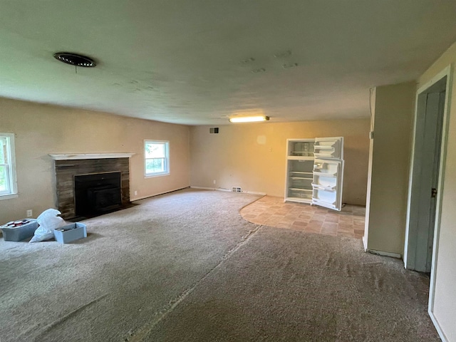 unfurnished living room featuring light carpet