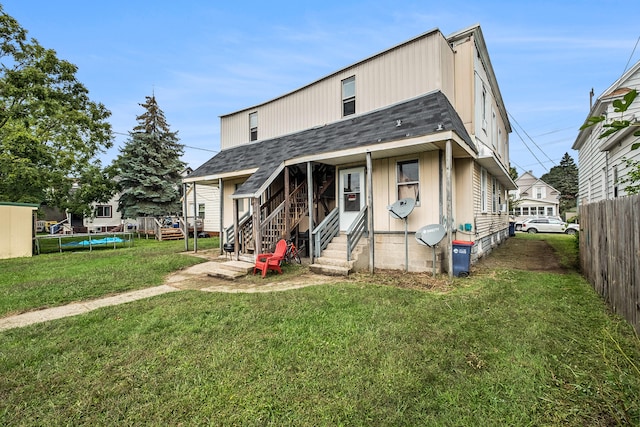 view of front facade with a front lawn and a trampoline