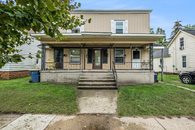 view of front of home with a front yard and a porch