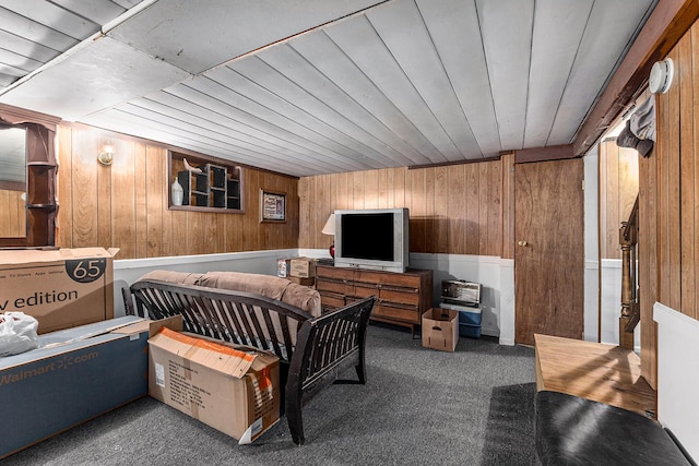 carpeted bedroom with wooden walls and wooden ceiling