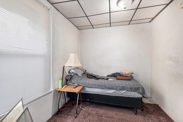 carpeted bedroom featuring a paneled ceiling