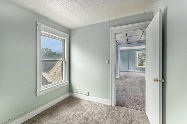 carpeted empty room with plenty of natural light