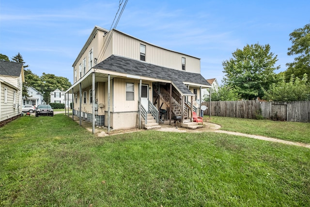 back of property featuring a lawn