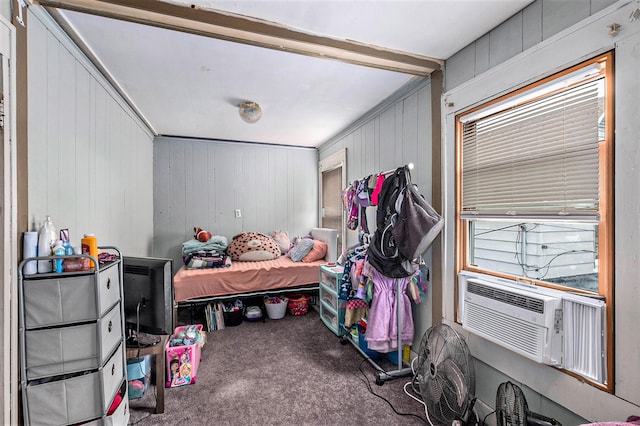 bedroom featuring cooling unit, wooden walls, crown molding, and carpet floors