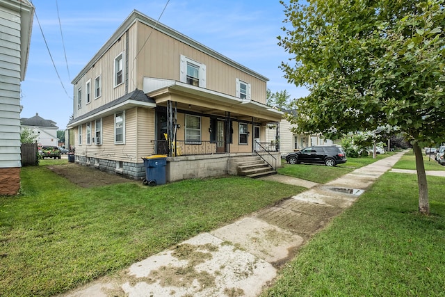 view of front of house with covered porch and a front lawn