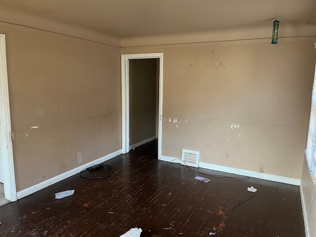 spare room featuring dark hardwood / wood-style floors