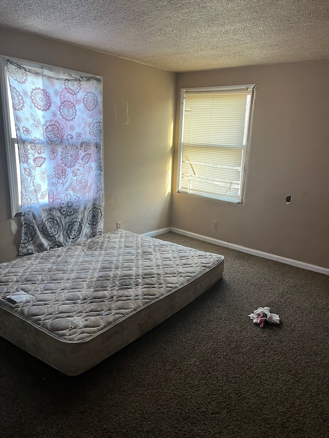 bedroom featuring a textured ceiling and carpet floors