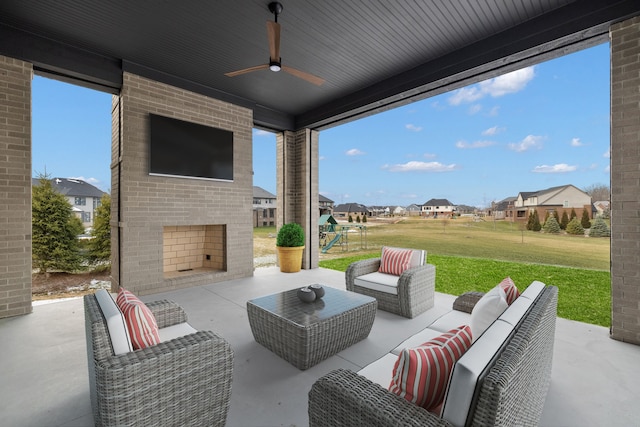 view of patio featuring an outdoor living space with a fireplace and ceiling fan