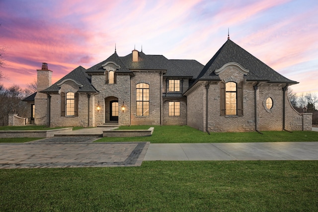 french country style house with a yard