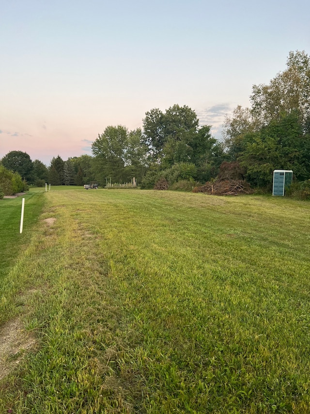 66930 Dorothy Trl, Washington, MI 48095 - yard at dusk featuring a lawn