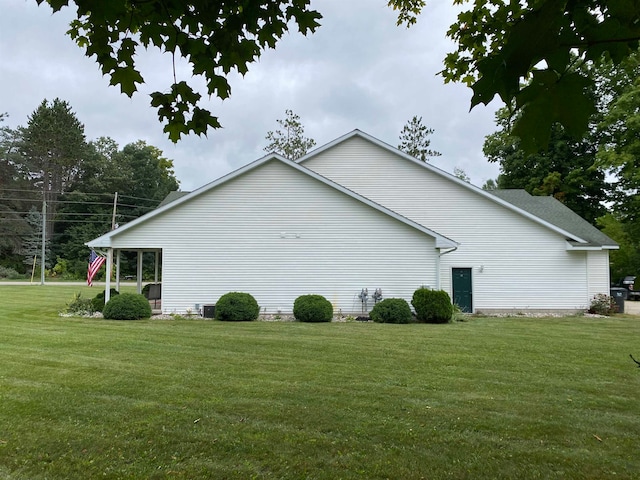 view of side of home featuring central air condition unit and a lawn