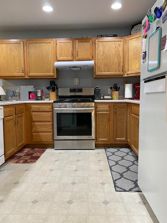 kitchen with white appliances, sink, and light tile patterned floors