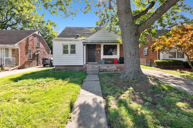 bungalow-style house featuring a front yard