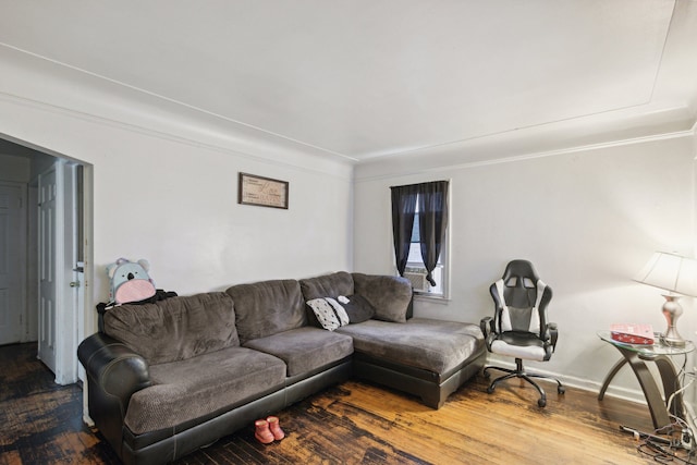 living room with hardwood / wood-style flooring and crown molding