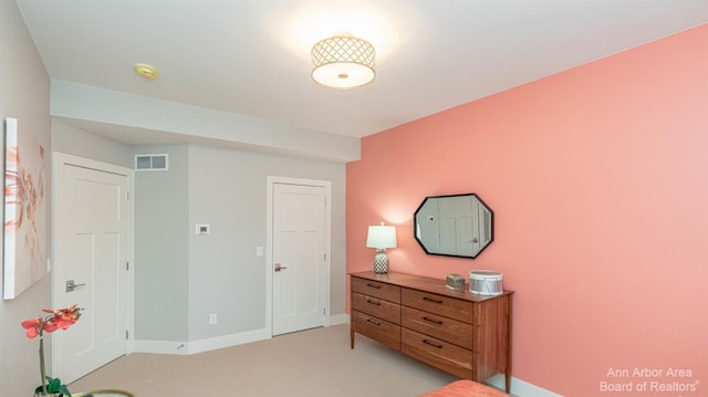 bedroom with light colored carpet