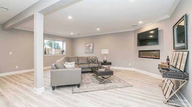 46 Gallery Pointe Dr, Saline, MI 48176 - living area featuring ornamental molding, light wood-style floors, baseboards, a glass covered fireplace, and recessed lighting