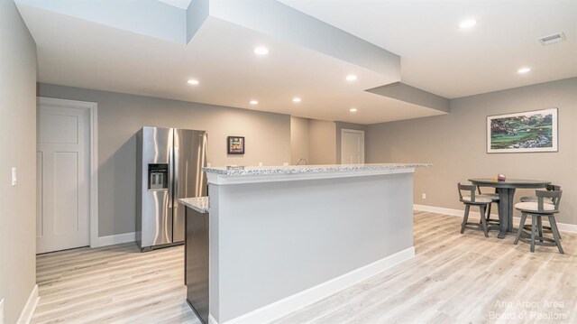 46 Gallery Pointe Dr, Saline, MI 48176 - kitchen with stainless steel fridge with ice dispenser, light wood finished floors, a center island, recessed lighting, and baseboards