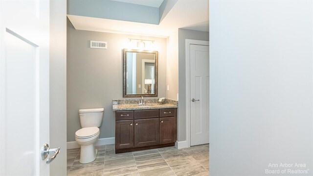 46 Gallery Pointe Dr, Saline, MI 48176 - bathroom with vanity, toilet, and baseboards