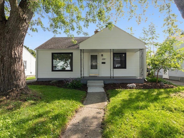 bungalow-style house with covered porch and a front yard