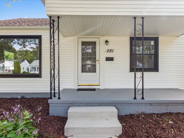 view of exterior entry with covered porch