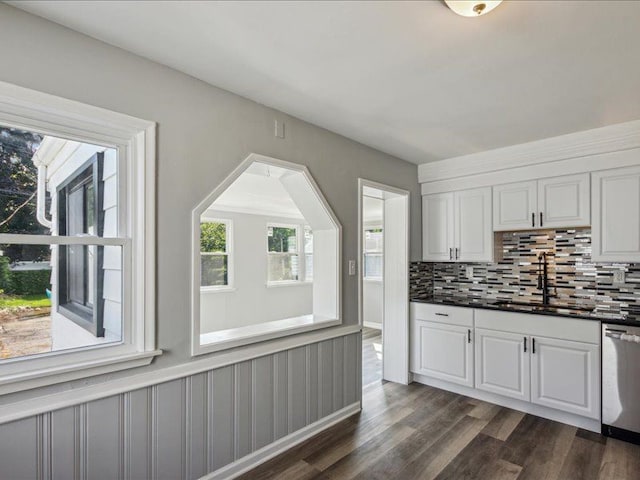 kitchen featuring white cabinets, dishwasher, and a wealth of natural light