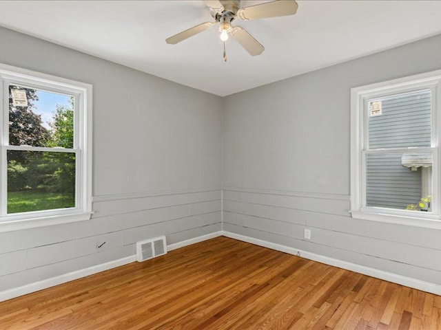 spare room featuring ceiling fan and light hardwood / wood-style flooring