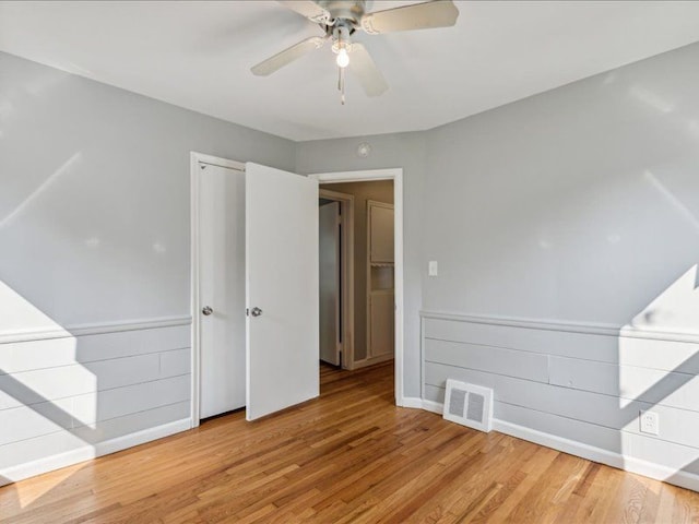 spare room with hardwood / wood-style floors and ceiling fan