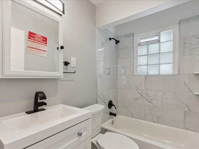 full bathroom with vanity, tiled shower / bath combo, and toilet