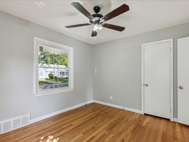 unfurnished bedroom with ceiling fan and light hardwood / wood-style flooring