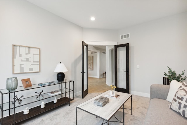 carpeted living room featuring french doors