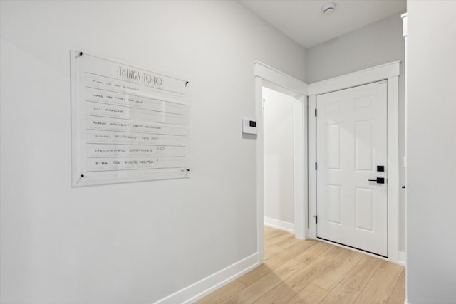 corridor with light hardwood / wood-style flooring