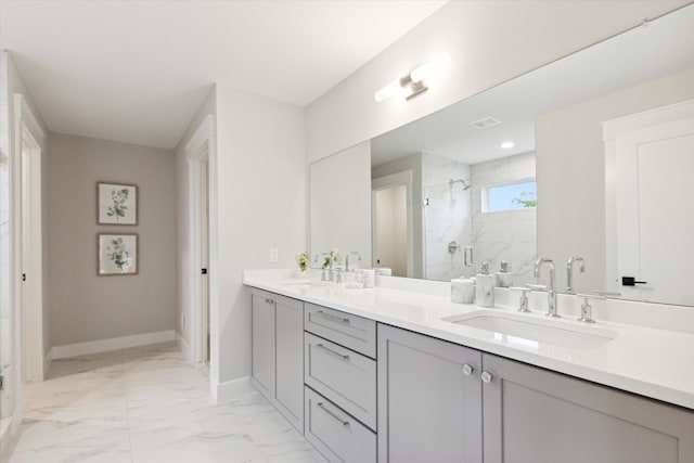 bathroom with vanity and a shower with door