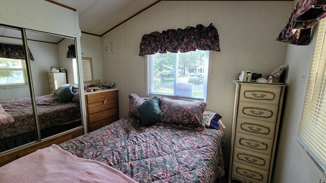 bedroom with hardwood / wood-style floors, ornamental molding, multiple windows, and a closet