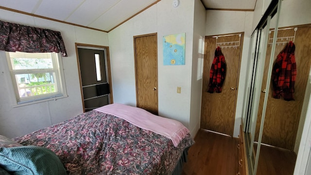 bedroom with wood-type flooring, lofted ceiling, and ornamental molding