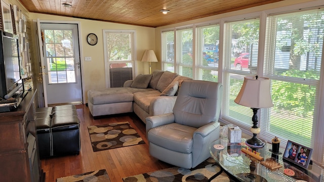 living room with hardwood / wood-style floors, wooden ceiling, lofted ceiling, and ornamental molding