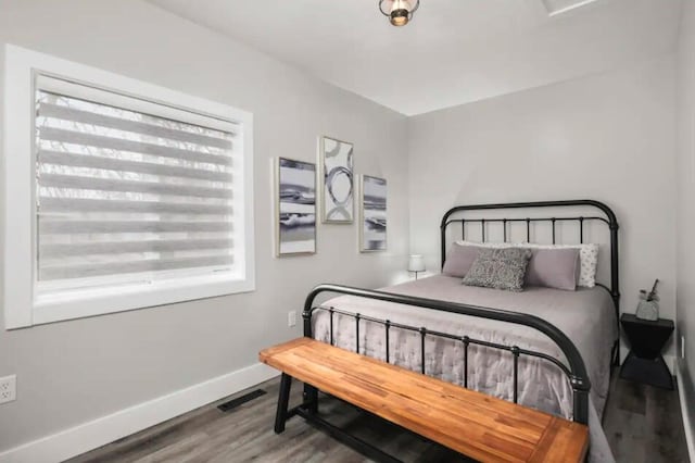 bedroom with wood-type flooring