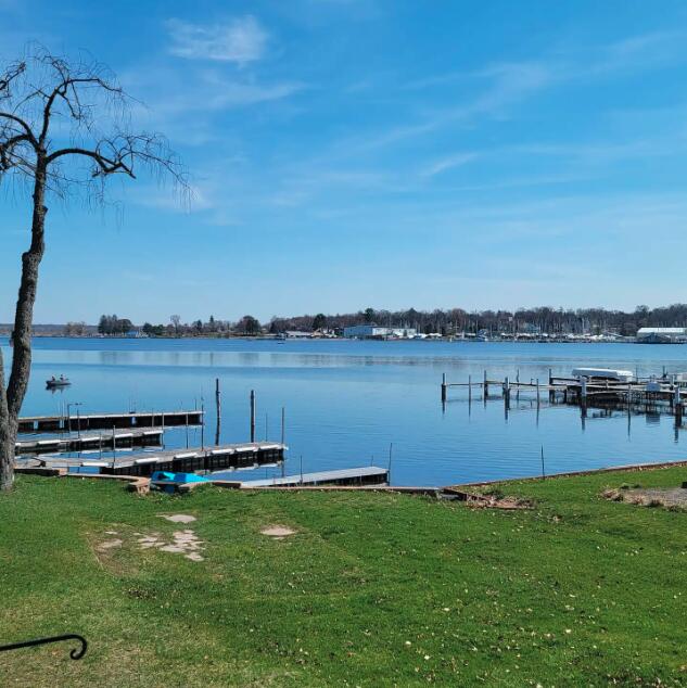 view of dock featuring a lawn and a water view