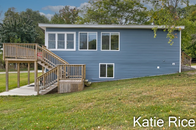 rear view of house with a deck and a lawn