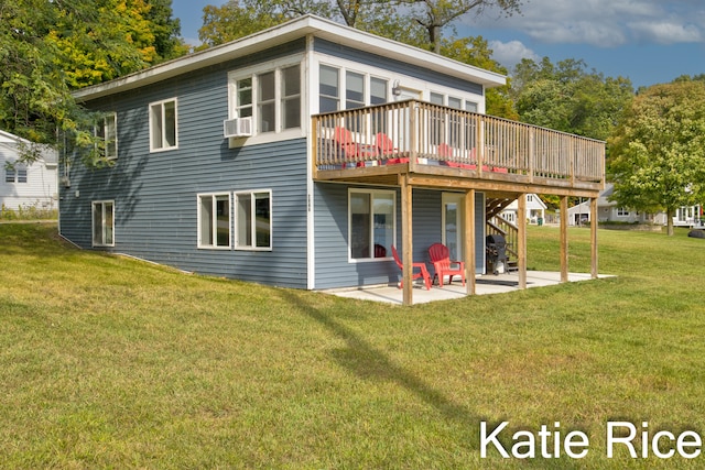 rear view of house featuring a lawn, a wooden deck, and a patio