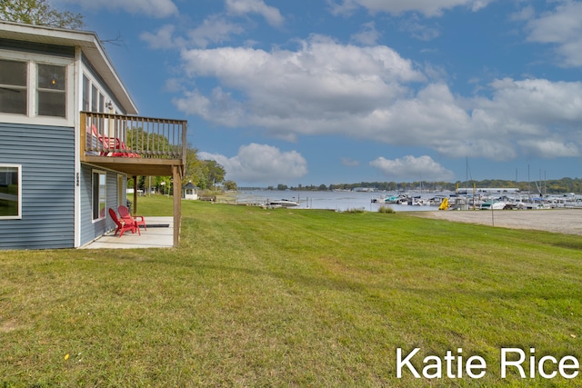 view of yard with a water view and a patio