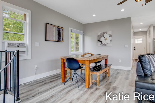 dining room featuring ceiling fan, cooling unit, and light wood-type flooring