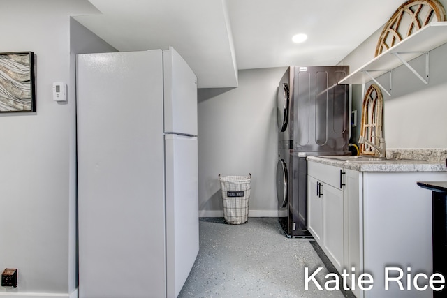 laundry room featuring stacked washer and dryer