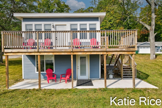 back of house featuring a lawn, a deck, and a patio