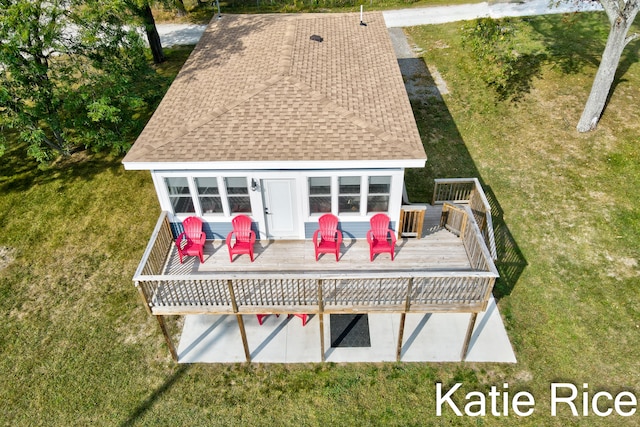 back of property featuring a yard and a wooden deck