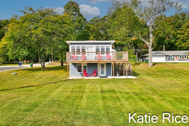 rear view of property featuring a yard, a deck, and a patio area