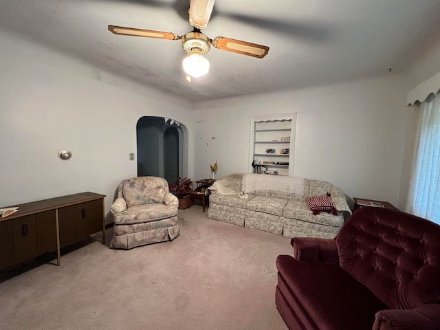 living room featuring light colored carpet and ceiling fan